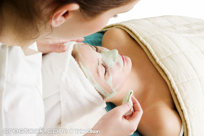 Detail of a facial mask treatment being wiped ...